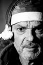 man with Santa Claus hat frontal view, black and white photo, with angry expression, Christmas is coming.