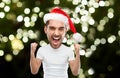 Man in santa hat celebrating victory at home Royalty Free Stock Photo