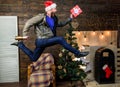 Man santa hat hurry to deliver gift on time. Christmas is coming. Spread happiness and joy. Bearded guy in motion jump Royalty Free Stock Photo