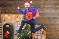 Man santa hat hurry to deliver gift on time. Spread happiness and joy. Bearded guy in motion jump. Delivery christmas Royalty Free Stock Photo