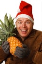 Man in Santa hat with pineapple.