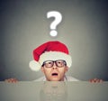 Man in santa hat with question mark wondering about gift Royalty Free Stock Photo