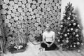 Man in santa hat sit on floor at Christmas tree Royalty Free Stock Photo