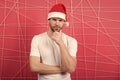 Man in santa hat touch beard on thinking face Royalty Free Stock Photo