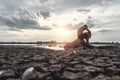 A man sat bent his knees on the base of the tree where the floor was dry and hands placed on the head Royalty Free Stock Photo