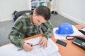 Man sat at desk working on blueprints Royalty Free Stock Photo