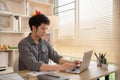 Man sat typing away on a laptop in his office with a determined look on his face Royalty Free Stock Photo