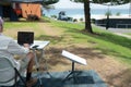 man with satellite internet dish connected working on computer at remote beach side campsite Royalty Free Stock Photo