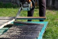 Man sawing boards with a chainsaw. Close up Royalty Free Stock Photo