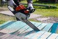 Man sawing boards with a chainsaw. Close up Royalty Free Stock Photo