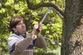 Man sawing a branch with an handsaw