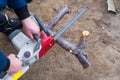 A man is sawing a fallen tree with an electric chain saw Royalty Free Stock Photo