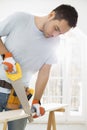 Man sawing wood in new house Royalty Free Stock Photo