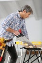 Man sawing wood working on home improvement Royalty Free Stock Photo