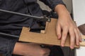 a man sawing a wooden detail with a jigsaw, closeup hands Royalty Free Stock Photo