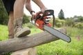 A man saws off a log with a chainsaw Royalty Free Stock Photo