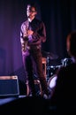 Man with saxophone. Silouette of listener in first row