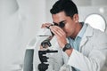 Man, scientist and microscope in forensic, research or new science discovery at laboratory. Male person, medical or