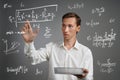 Man scientist or student working with various high school maths and science formulas. Royalty Free Stock Photo