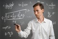 Man scientist or student working with various high school maths and science formulas. Royalty Free Stock Photo