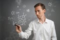 Man scientist with stylus or pen working with chemical formulas on gray background.