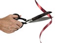 Man with scissors cuts red tape over white