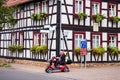 Man on a scooter in front of a house in Germany