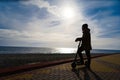 Man on scooter at sunset, silhouette, free space