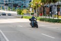 Man on a scooter wearing a mask and gloves to prevent spread of Coronavirus Covid 19