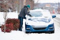 Man Scraping Ice off Car