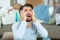 man screaming in despair surrounded by laundry Royalty Free Stock Photo