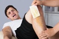 Therapist Waxing Man`s Leg With Wax Strip Royalty Free Stock Photo