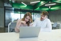 man screams for a girl who is sitting at a computer, a failure at work. Boss weld worker. Aggression in the office Royalty Free Stock Photo