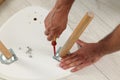 Man with screwdriver assembling stool on floor, above view Royalty Free Stock Photo