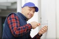 Man screws on wall Royalty Free Stock Photo