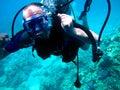 Man scuba diver and beautiful colorful coral reef underwater Royalty Free Stock Photo