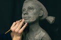 Man sculptor creates sculpt bust clay human woman sculpture. Statue craft creation workshop