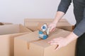 Man sealing a shipping cardboard box Royalty Free Stock Photo