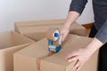 Man sealing a shipping cardboard box Royalty Free Stock Photo