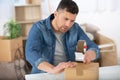 man sealing with tape sitting on floor Royalty Free Stock Photo