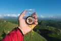 Man searching direction with a compass in his hand in the summer mountains point of view. Direction Search Royalty Free Stock Photo