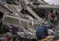 Man searching for goods in modern destroyed building ruins close