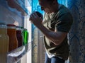 Man searching inside his fridge at night Royalty Free Stock Photo
