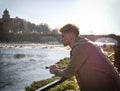 Man sitting on bench by water Royalty Free Stock Photo