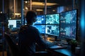 A man seated at a desk, focused on his work, with three computer monitors in front of him, Programmer working in a software Royalty Free Stock Photo