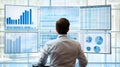 A man is seated in front of multiple computer monitors displaying various graphical data Royalty Free Stock Photo