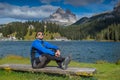 Man seating on bench near lago di misurina in sout tyrol, italien dolomites, tre cime di lavaredo Royalty Free Stock Photo