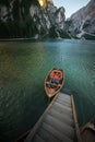 Man seating on boat on lago di braies, italien dolomites, travel and adventure photography