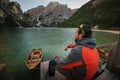 Man seating on boat on lago di braies, italien dolomites, travel and adventure photography