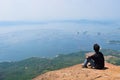 Man seating on the top of lembu mountain Royalty Free Stock Photo